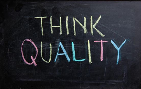 Handwriting text writing Think Quality on blackboard. Concept meaning always think of Quality