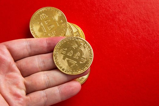 Man Hand holding a bitcoin on red background
