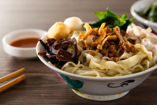 Pan Mee is made with a simple flour-based dough, with anchovy broth, and topped with crispy fried anchovies, ground pork, shiitake mushrooms, and some vegetables.
