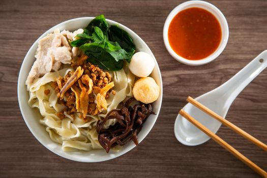 Pan Mee is made with a simple flour-based dough, with anchovy broth, and topped with crispy fried anchovies, ground pork, shiitake mushrooms, and some vegetables.