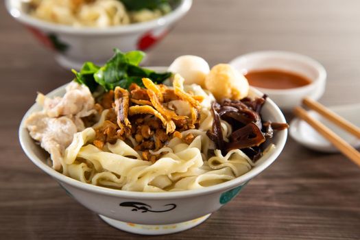 Pan Mee is made with a simple flour-based dough, with anchovy broth, and topped with crispy fried anchovies, ground pork, shiitake mushrooms, and some vegetables.