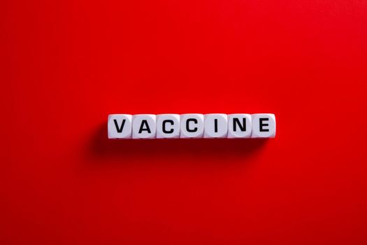 Medical covid-19 concept. Words of 'vaccine' on red background