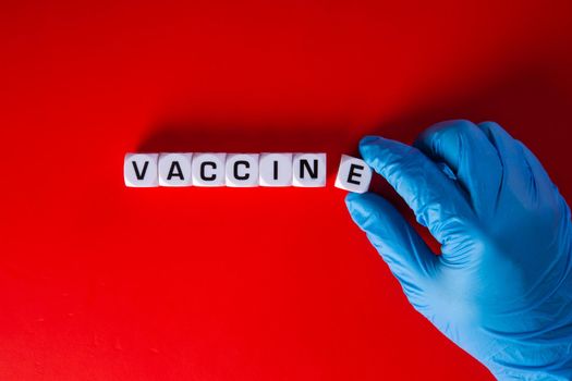 Doctor hand  with words 'vaccine'. Medical covid-19 concept