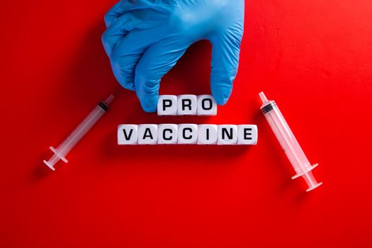 Pro-vaccine symbol. Doctor hand  with words 'pro-vaccine'. Medical covid-19 pro-vaccine concept.
