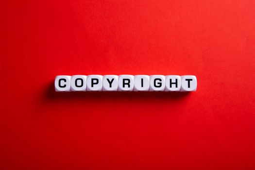 Copyright word on red background. Concept of legal education.