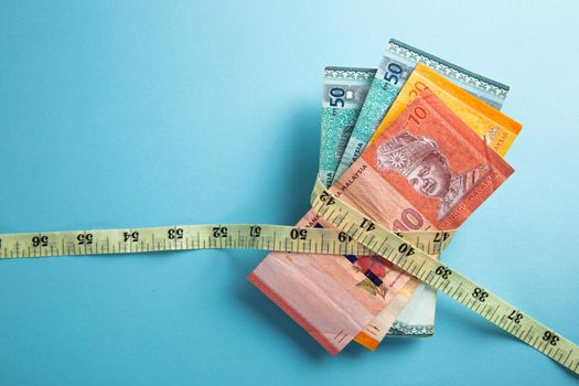 Money with a tape measure. Inflation rates. Price growth.