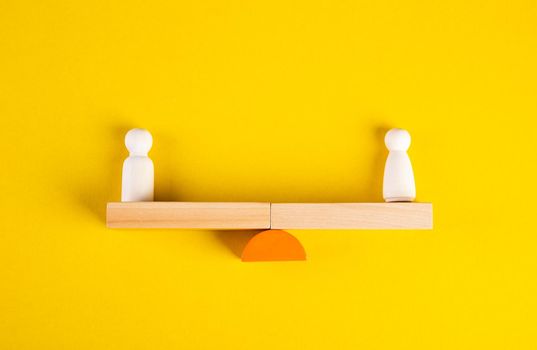 Gender Equality Concept. Male And Female Balancing On Seesaw