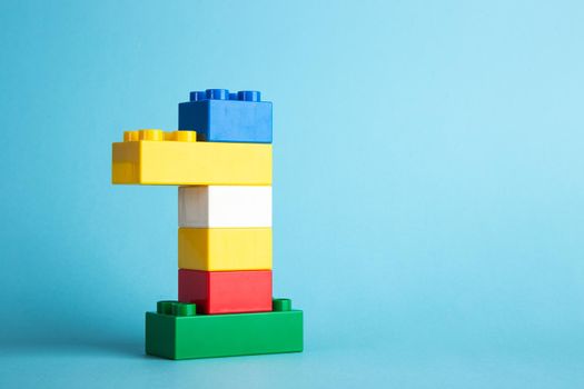 Plastic building blocks on blue background