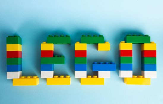 Plastic building blocks on blue background