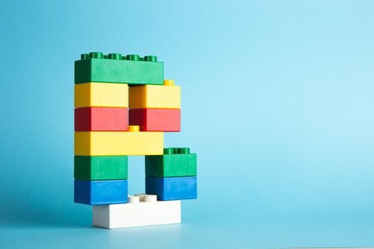 Plastic building blocks on blue background
