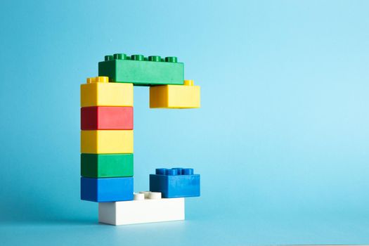 Plastic building blocks on blue background