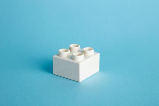 Plastic building blocks on blue background