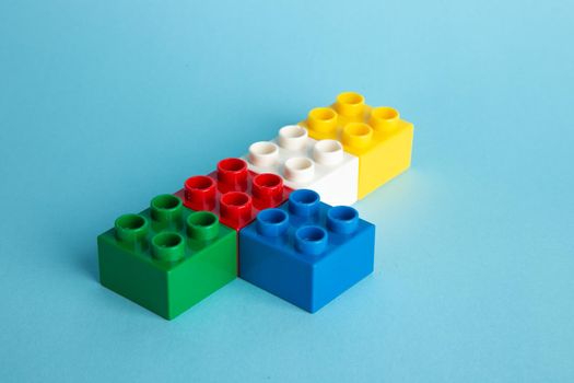Plastic building blocks on blue background