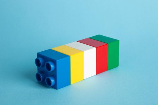 Plastic building blocks on blue background