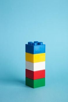 Plastic building blocks on blue background