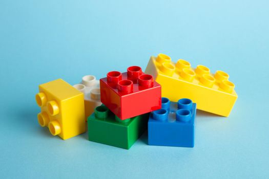 Plastic building blocks on blue background