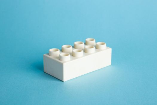 Plastic building blocks on blue background