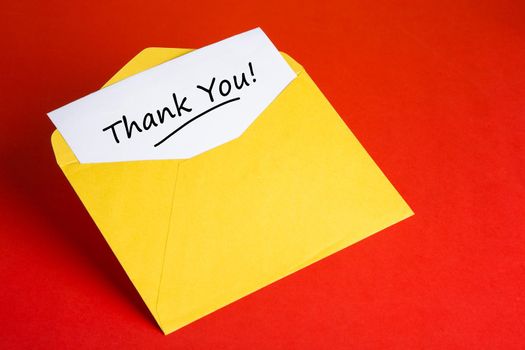 Yellow envelope with words THANK YOU on red background