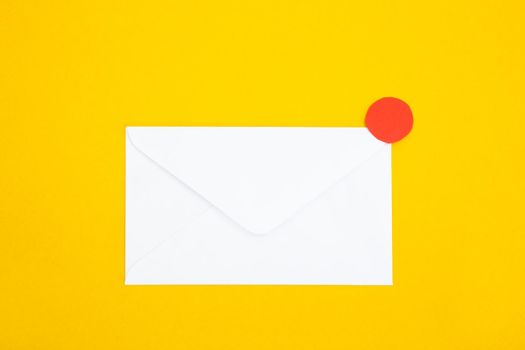 Colorful paper envelopes on yellow background - top view