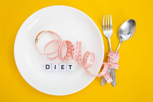 Measuring tape on a fork and knife - dieting concept