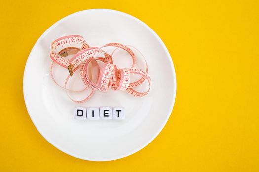 Measuring tape on a fork and knife - dieting concept