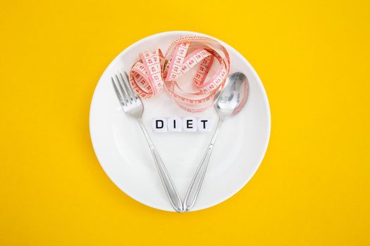 Measuring tape on a fork and knife - dieting concept