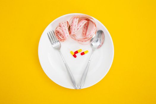Measuring tape on a fork and knife - dieting concept