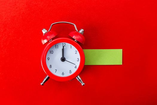 Alarm clock on red background. Copy Space
