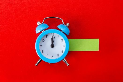 Alarm clock on red background. Copy Space