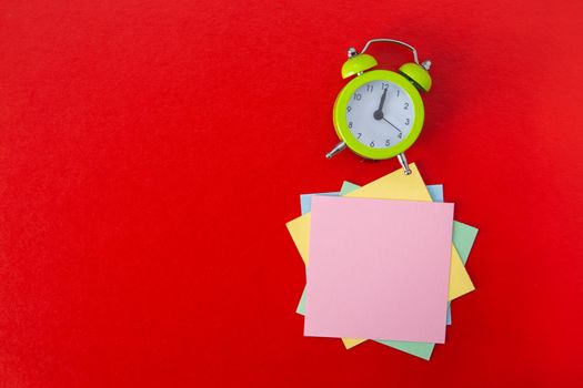 Alarm clock on red background. Copy Space