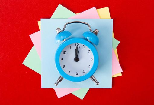Alarm clock on red background. Copy Space