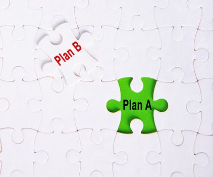 Plan A, Plan B on jigsaw puzzle background, business concept.