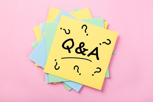 Sticky note on pink background, Question And Answer