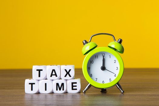 Time For Taxes Reminder Concept on yellow background