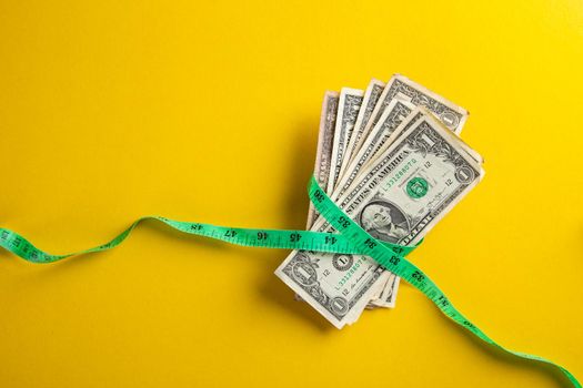 Money with a tape measure. Inflation rates. Price growth.