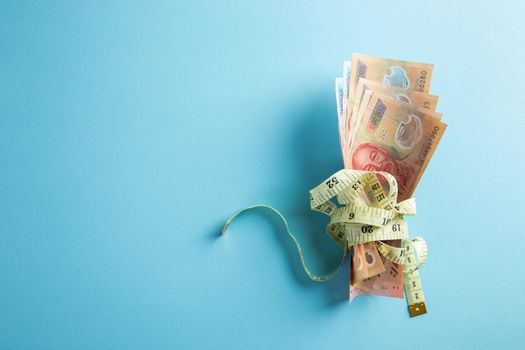 Money with a tape measure. Inflation rates. Price growth.