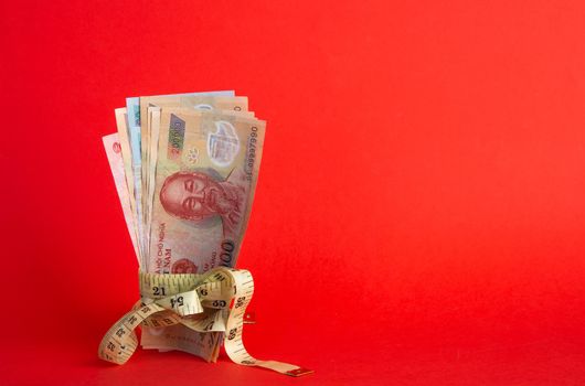 Money with a tape measure. Inflation rates. Price growth.