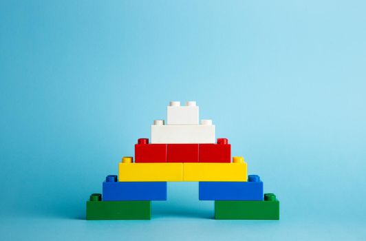 Plastic building blocks on red background