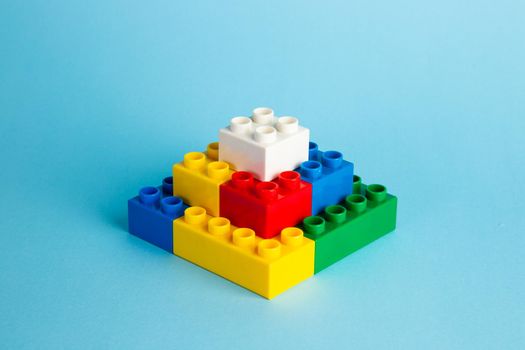 Plastic building blocks on red background