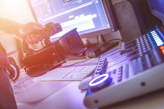Video editing, recording and cutting room with monitors, camera and sound mixing desk