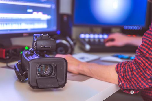 Video editing, recording and cutting room with monitors, camera and sound mixing desk