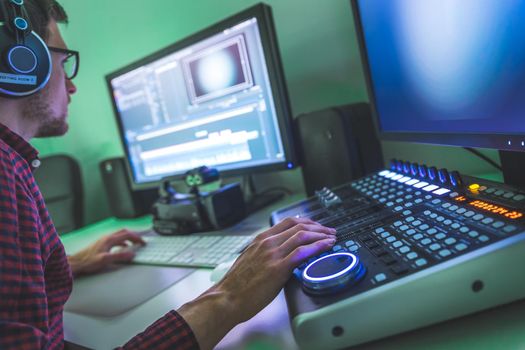 Video editing, recording and cutting room with monitors and sound mixing desk