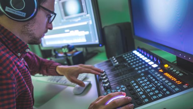 Video editing, recording and cutting room with monitors and sound mixing desk