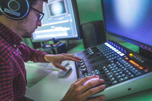 Video editing, recording and cutting room with monitors and sound mixing desk