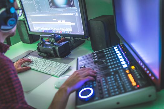 Video editing, recording and cutting room with monitors and sound mixing desk