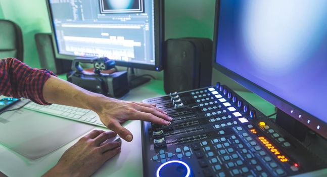 Video editing, recording and cutting room with monitors and sound mixing desk