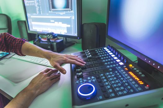 Video editing, recording and cutting room with monitors and sound mixing desk