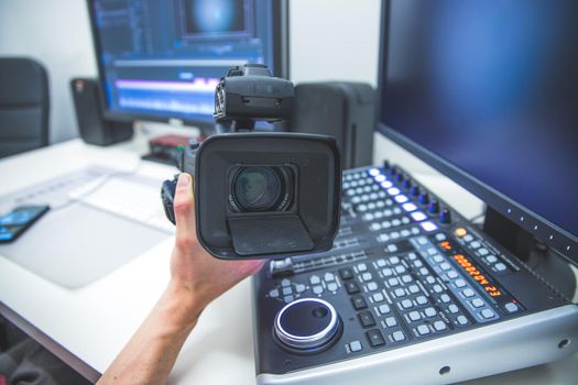 Video editing, recording and cutting room with monitors, camera and sound mixing desk