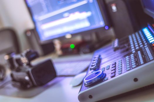 Video editing, recording and cutting room with monitors, camera and sound mixing desk