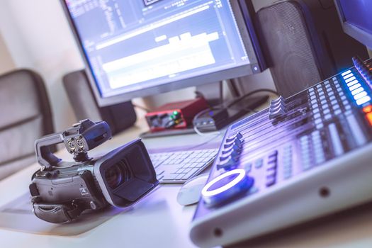 Video editing, recording and cutting room with monitors, camera and sound mixing desk